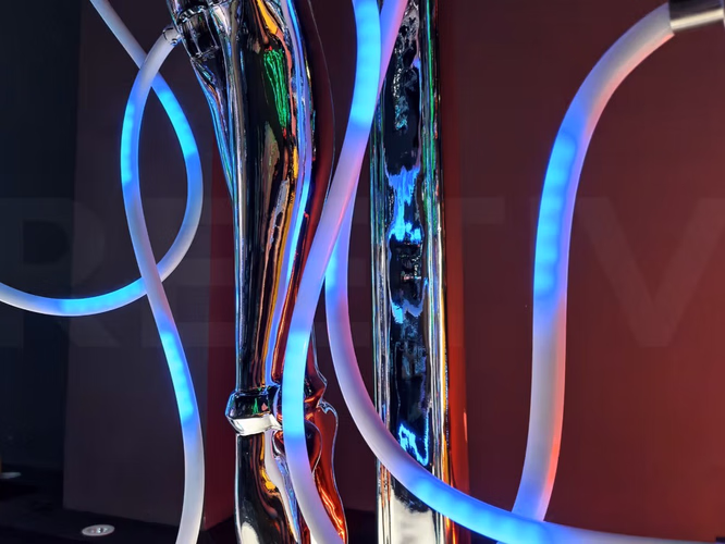Color-changing RGB LED tubes on mirror future goddess kinetic art