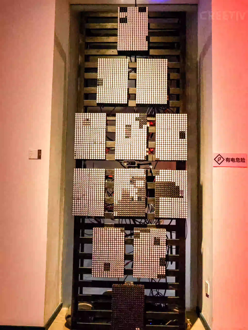 Full view of large Flip-Dot Kinetic Wall showing high-resolution interactive pixel portrait