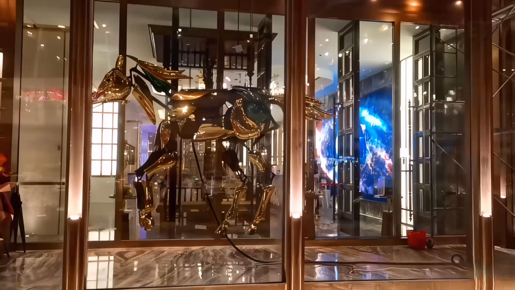 Golden mechanical horse sculpture at Dihao Private Club Shenyang entrance at night