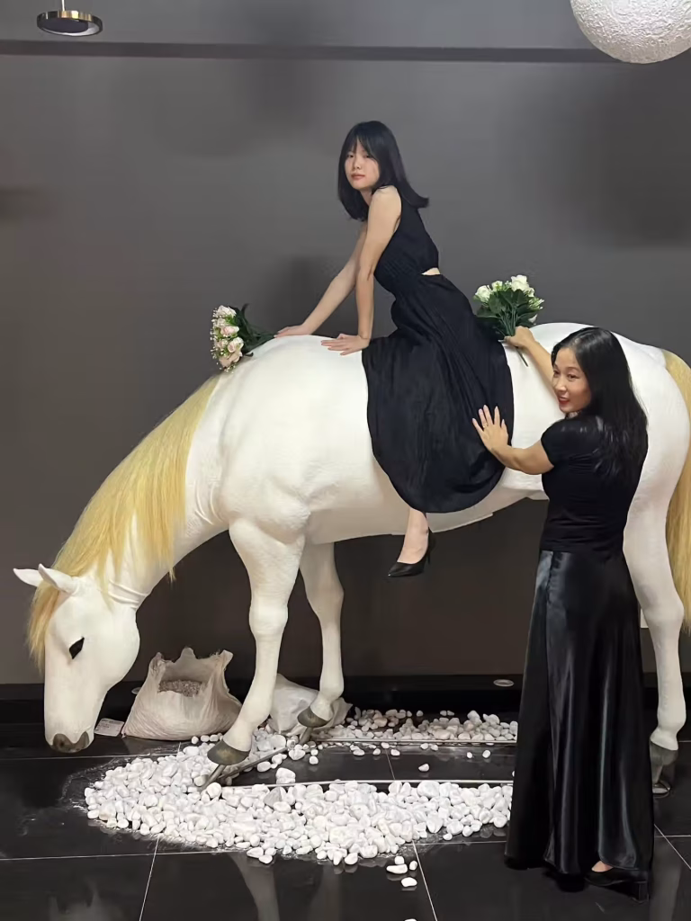 Young visitor riding Creetiv bionic horse sculpture in Zhuhai shopping mall – joyful interaction December 2025